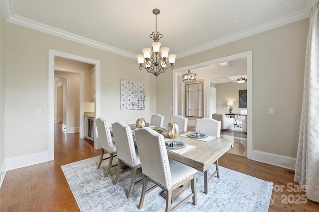 3032 Kings Manor Dr, Matthews, NC 28104 - dining space featuring ornamental molding, a chandelier, and wood finished floors