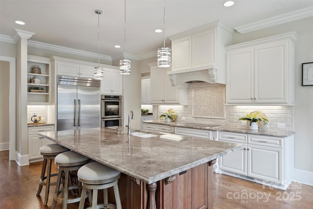 3032 Kings Manor Dr, Matthews, NC 28104 - kitchen with appliances with stainless steel finishes, wood finished floors, white cabinetry, recessed lighting, and crown molding