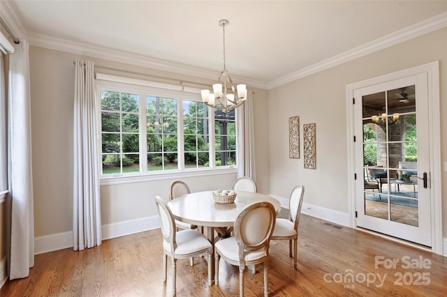 3032 Kings Manor Dr, Matthews, NC 28104 - dining space with a chandelier, ornamental molding, and light wood finished floors