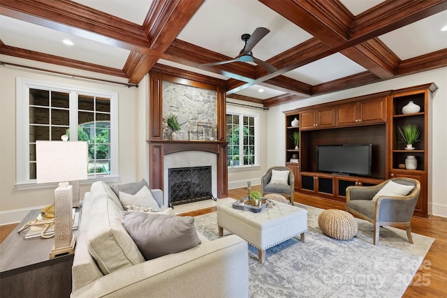 3032 Kings Manor Dr, Matthews, NC 28104 - living room featuring a ceiling fan, light wood-type flooring, a high end fireplace, ornamental molding, and beam ceiling