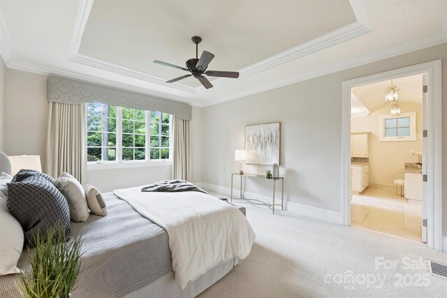 3032 Kings Manor Dr, Matthews, NC 28104 - carpeted bedroom featuring a raised ceiling, crown molding, connected bathroom, and a ceiling fan