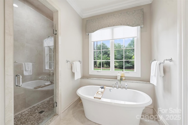 3032 Kings Manor Dr, Matthews, NC 28104 - bathroom featuring ornamental molding, a freestanding bath, a stall shower, and marble finish flooring