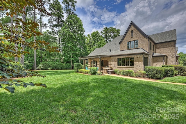 3032 Kings Manor Dr, Matthews, NC 28104 - back of property featuring brick siding, a lawn, and roof with shingles