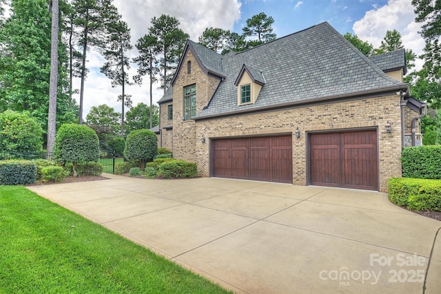 3032 Kings Manor Dr, Matthews, NC 28104 - view of side of property featuring a high end roof, brick siding, concrete driveway, and an attached garage