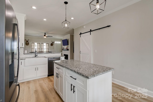 1202 Neds Creek Rd, Kershaw, SC 29067 - kitchen with stainless steel appliances, a ceiling fan, a center island, crown molding, and a sink