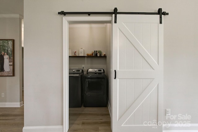 1202 Neds Creek Rd, Kershaw, SC 29067 - laundry room featuring wood finished floors, independent washer and dryer, a barn door, and baseboards