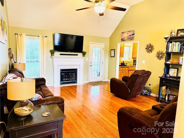 104 Laura Ct, Cherryville, NC 28021 - living room featuring a ceiling fan, wood finished floors, a fireplace with flush hearth, healthy amount of natural light, and high vaulted ceiling