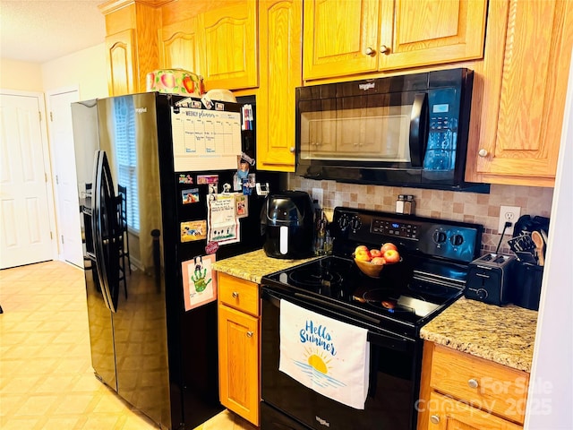 104 Laura Ct, Cherryville, NC 28021 - kitchen featuring black appliances, tasteful backsplash, light floors, and light stone counters