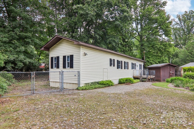 68 Cornwell Dr, Waynesville, NC 28786 - view of home's exterior with a gate and view of scattered trees