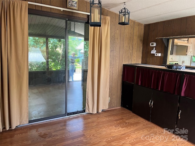 68 Cornwell Dr, Waynesville, NC 28786 - kitchen with wooden walls, under cabinet range hood, and wood finished floors