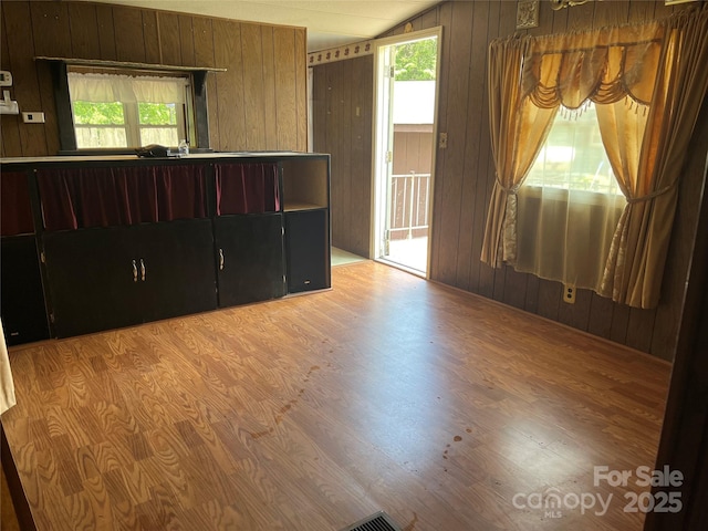 68 Cornwell Dr, Waynesville, NC 28786 - unfurnished room featuring light wood-style floors, wooden walls, healthy amount of natural light, and lofted ceiling