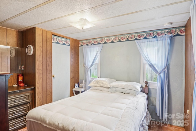 68 Cornwell Dr, Waynesville, NC 28786 - bedroom featuring wooden walls and a textured ceiling