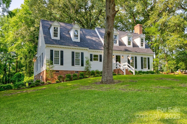 325 Chapman St, Chesterfield, SC 29709 - new england style home with a front yard, a chimney, crawl space, view of wooded area, and a shingled roof