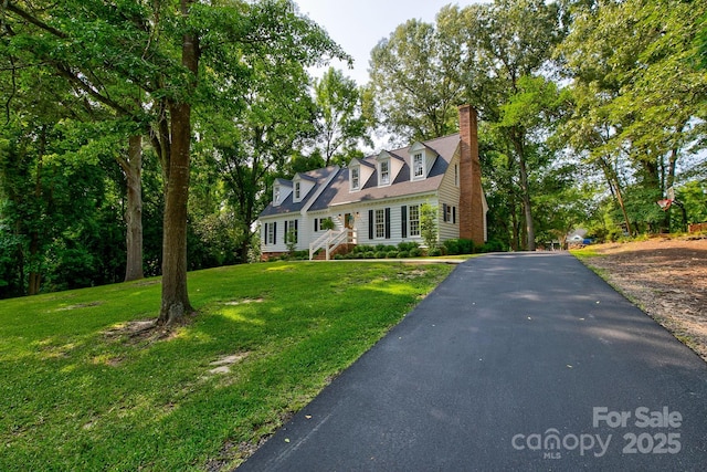 325 Chapman St, Chesterfield, SC 29709 - cape cod-style house with driveway, a chimney, and a front yard