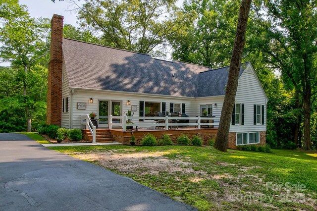 325 Chapman St, Chesterfield, SC 29709 - cape cod home with a chimney, a wooden deck, roof with shingles, and a front yard