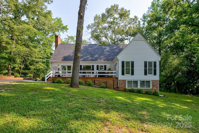 325 Chapman St, Chesterfield, SC 29709 - view of front of property with a front yard, a wooden deck, a chimney, and brick siding