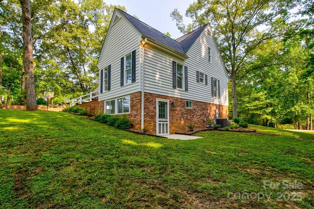 325 Chapman St, Chesterfield, SC 29709 - view of side of property featuring brick siding, a yard, and central AC