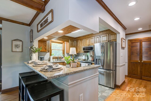 325 Chapman St, Chesterfield, SC 29709 - kitchen with appliances with stainless steel finishes, ornamental molding, a peninsula, light stone countertops, and recessed lighting