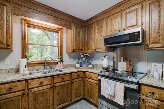 325 Chapman St, Chesterfield, SC 29709 - kitchen with appliances with stainless steel finishes, a sink, and brown cabinets