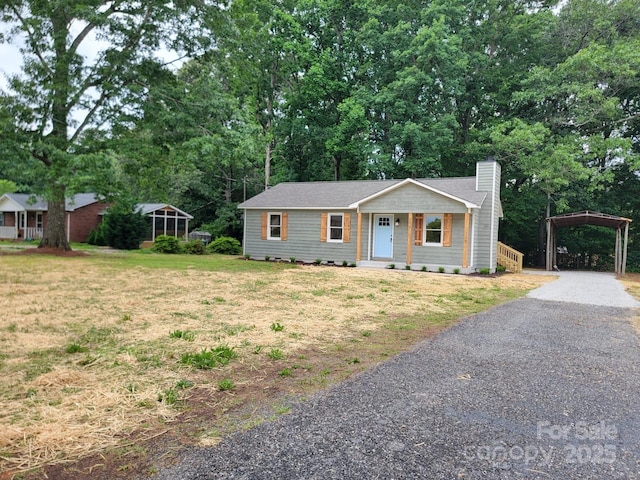2070 Stirewalt Rd, China Grove, NC 28023 - single story home featuring a chimney, a front lawn, driveway, and a detached carport