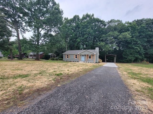 2070 Stirewalt Rd, China Grove, NC 28023 - ranch-style home with a detached carport, a chimney, a front lawn, and gravel driveway