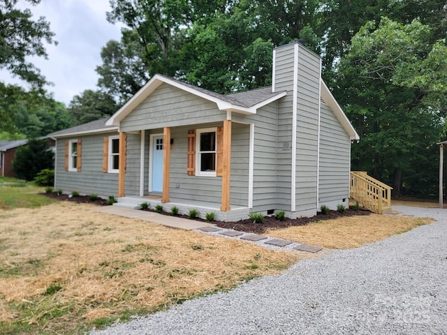 2070 Stirewalt Rd, China Grove, NC 28023 - view of front of home with covered porch, crawl space, a chimney, a shingled roof, and view of wooded area