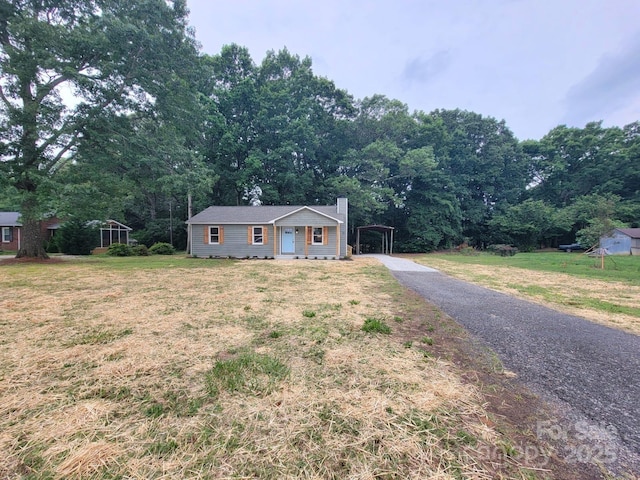 2070 Stirewalt Rd, China Grove, NC 28023 - ranch-style home with a carport, a chimney, a front yard, and asphalt driveway
