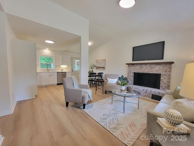2070 Stirewalt Rd, China Grove, NC 28023 - living room with light wood-style flooring, a brick fireplace, lofted ceiling, and baseboards
