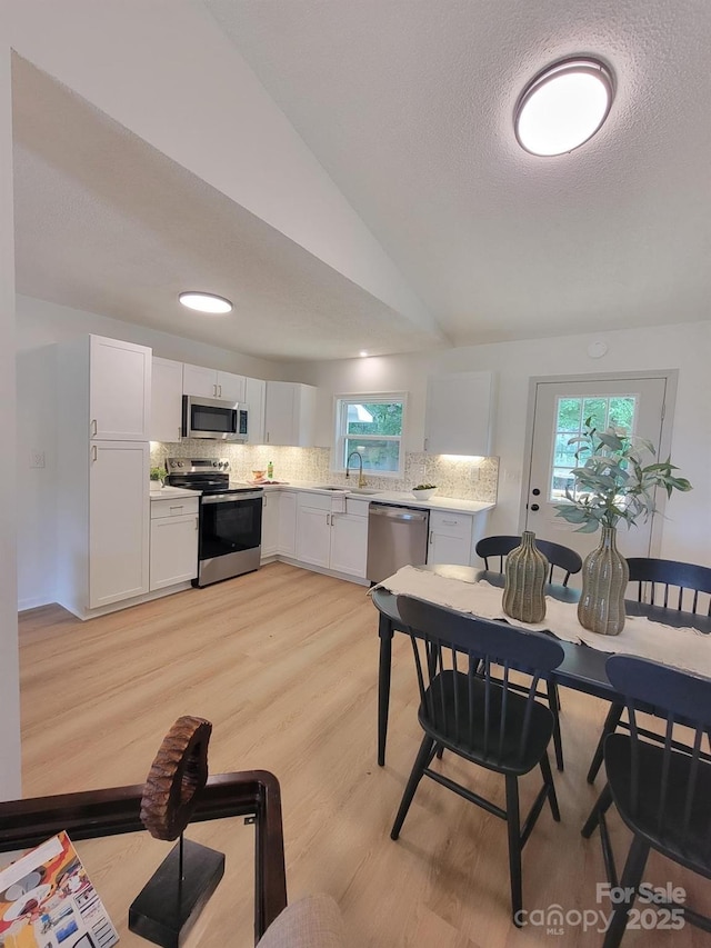 2070 Stirewalt Rd, China Grove, NC 28023 - dining room with plenty of natural light, light wood-style flooring, a textured ceiling, and lofted ceiling