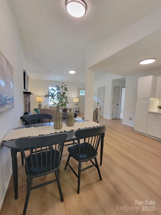 2070 Stirewalt Rd, China Grove, NC 28023 - dining space with light wood-style floors, baseboards, and a textured ceiling