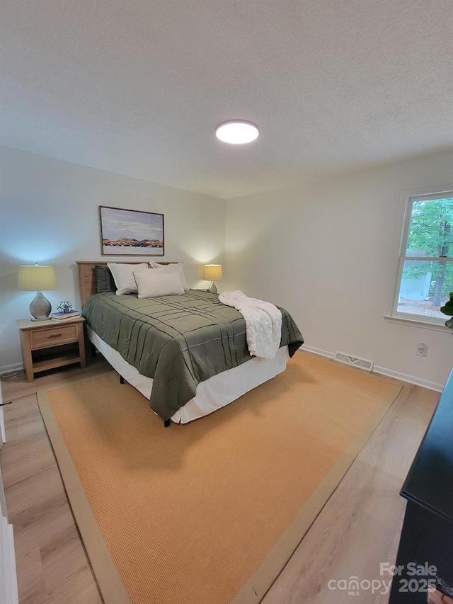 2070 Stirewalt Rd, China Grove, NC 28023 - bedroom featuring light wood-style flooring, baseboards, and a textured ceiling