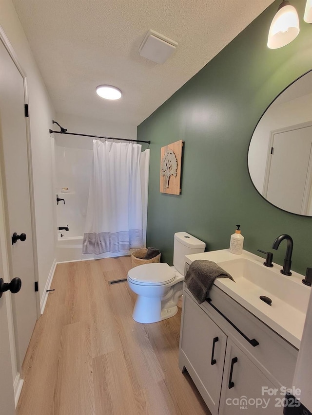 2070 Stirewalt Rd, China Grove, NC 28023 - full bath featuring vanity, toilet, wood finished floors, and a textured ceiling
