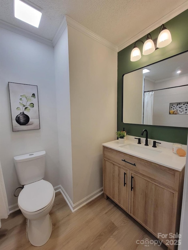 2070 Stirewalt Rd, China Grove, NC 28023 - full bathroom featuring wood finished floors, crown molding, toilet, vanity, and baseboards