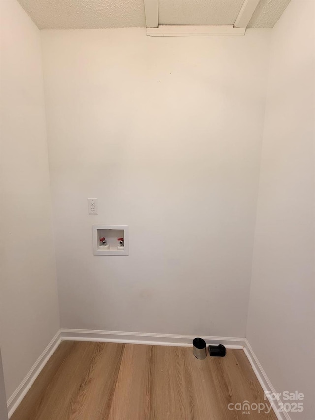 2070 Stirewalt Rd, China Grove, NC 28023 - laundry area featuring washer hookup, wood finished floors, and baseboards