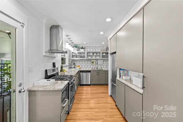 2424 Cumberland Ave, Charlotte, NC 28203 - kitchen with stainless steel appliances, extractor fan, gray cabinets, light wood-type flooring, and light stone countertops