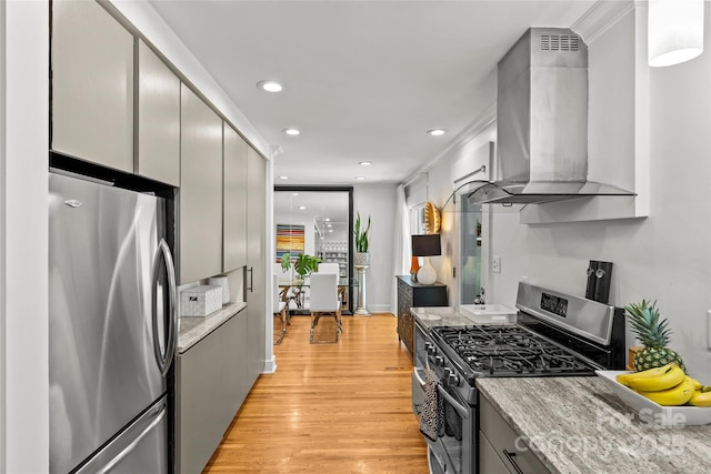 2424 Cumberland Ave, Charlotte, NC 28203 - kitchen with appliances with stainless steel finishes, ventilation hood, light wood-type flooring, recessed lighting, and light stone countertops