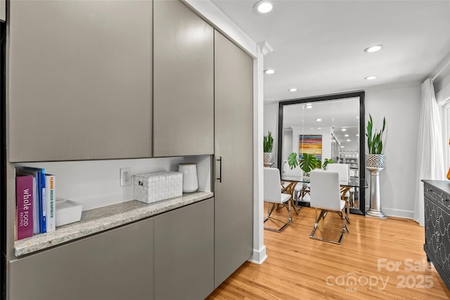 2424 Cumberland Ave, Charlotte, NC 28203 - kitchen featuring light wood-style flooring, recessed lighting, gray cabinets, light stone counters, and modern cabinets