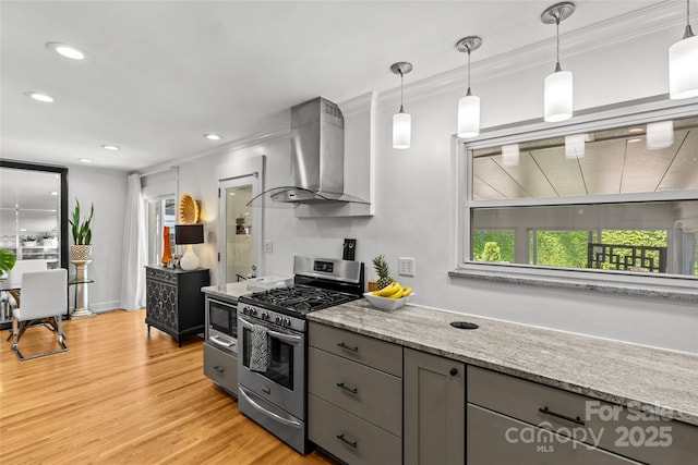 2424 Cumberland Ave, Charlotte, NC 28203 - kitchen featuring appliances with stainless steel finishes, wall chimney exhaust hood, gray cabinetry, light wood-style flooring, and light stone countertops