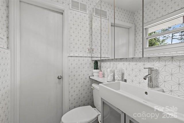 2424 Cumberland Ave, Charlotte, NC 28203 - bathroom with toilet, vanity, and tile walls