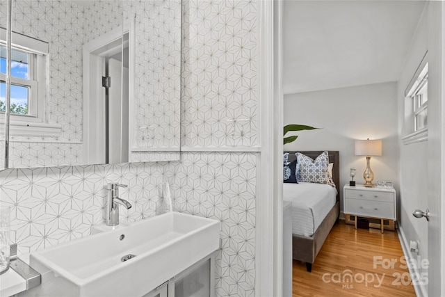 2424 Cumberland Ave, Charlotte, NC 28203 - ensuite bathroom with wood finished floors and vanity