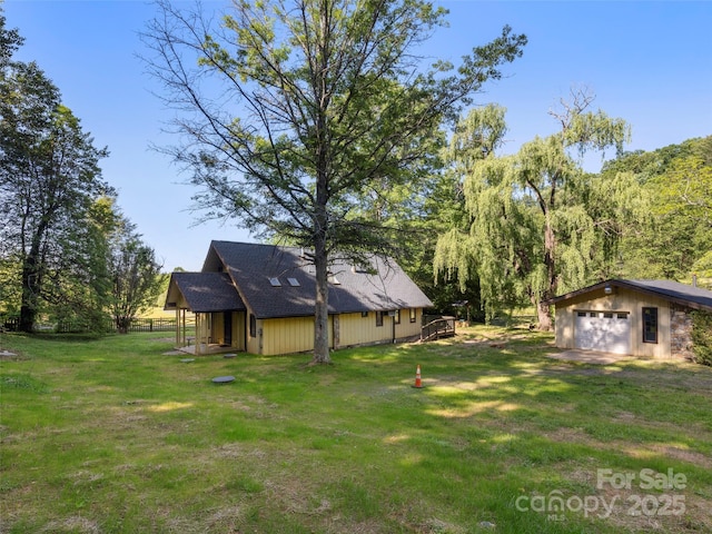 272 Pinners Cove Rd, Asheville, NC 28803 - view of grassy yard featuring a garage, an outdoor structure, and driveway