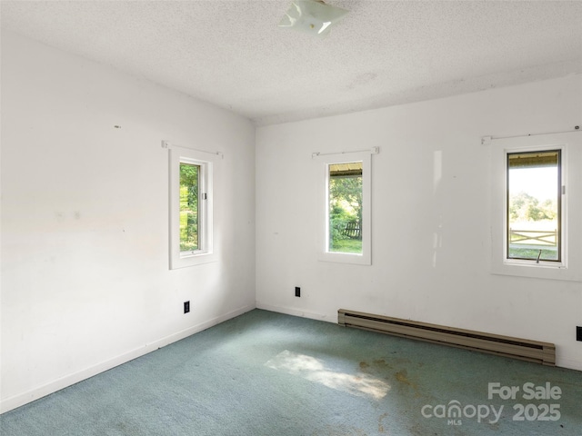 272 Pinners Cove Rd, Asheville, NC 28803 - carpeted spare room featuring a baseboard heating unit, plenty of natural light, a textured ceiling, and baseboards