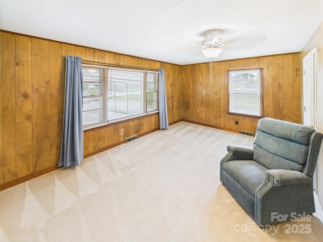 271 NC-16 Hwy N, Taylorsville, NC 28681 - sitting room with light carpet, wood walls, baseboards, and a ceiling fan