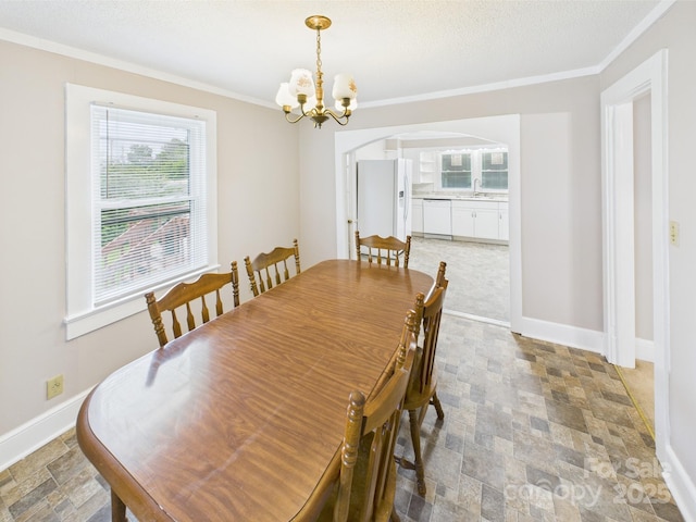 271 NC-16 Hwy N, Taylorsville, NC 28681 - dining room featuring arched walkways, crown molding, stone finish flooring, a chandelier, and baseboards