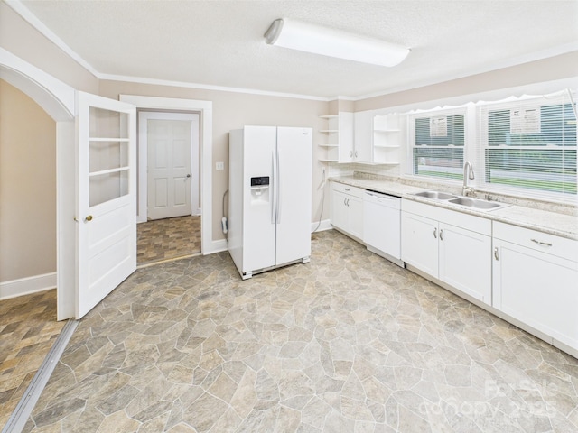 271 NC-16 Hwy N, Taylorsville, NC 28681 - kitchen featuring white appliances, a sink, open shelves, stone floors, and arched walkways
