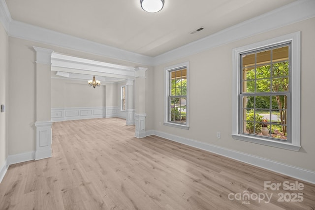 10508 Kristens Mare Dr, Charlotte, NC 28277 - spare room with a chandelier, ornamental molding, light wood finished floors, and decorative columns