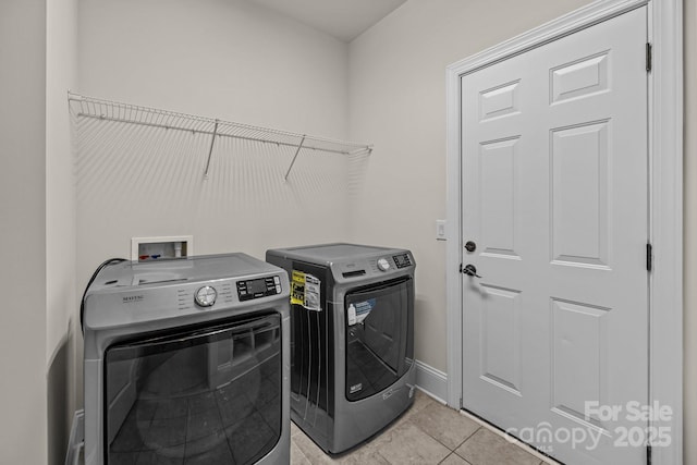 10508 Kristens Mare Dr, Charlotte, NC 28277 - laundry area with independent washer and dryer, light tile patterned floors, and baseboards