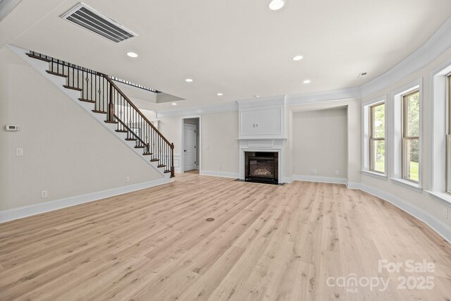 10508 Kristens Mare Dr, Charlotte, NC 28277 - unfurnished living room featuring light wood-type flooring, stairs, baseboards, crown molding, and recessed lighting