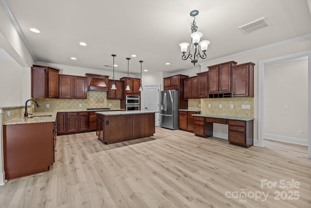 10508 Kristens Mare Dr, Charlotte, NC 28277 - kitchen featuring stainless steel appliances, a sink, backsplash, a center island, and crown molding