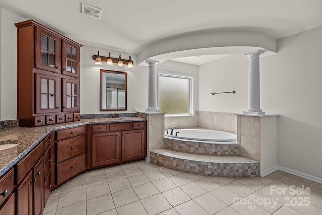 10508 Kristens Mare Dr, Charlotte, NC 28277 - full bath featuring ornate columns, double vanity, tile patterned flooring, and a bath
